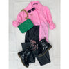 flat lay of black leather jeans, pink shirt, black boots and green bag