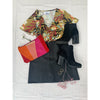 flat lay of tropical print top and black mini skirt