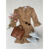 flat lay of gold mini dress with brown bag and white shoes