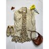 flat lay of animal print dress, cream coat and brown bag