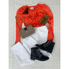 flat lay of orange top, white jeans, gucchu bag and black boots