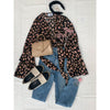 flat lay of animal print top and blue jeans