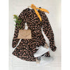 flat lay of animal print dress with beige bag and white shoes